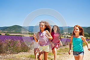 Happy playmates running through lavender field