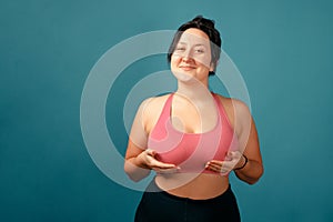 Happy plus size positive woman. Happy body positive concept. I love my body. Attractive overweight woman posing on camera in the