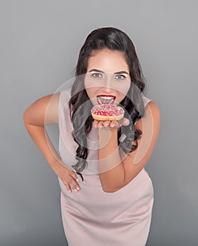 Happy plus size woman with donut. Body positive concept