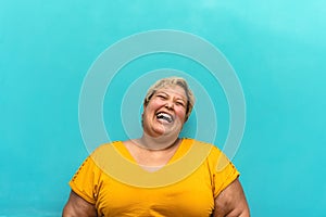 Happy plus size woman portrait - Curvy overweight model having fun smiling at camera