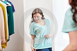 Happy plus size woman posing at home mirror