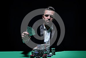 Happy poker player winning and holding a pair of aces