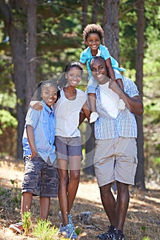 Happy, portrait and black family in forest bonding, fun or walking in nature together. Love, support and children with