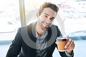 Happy, portrait and businessman with coffee for morning or start at cafe or indoor restaurant. Young man or employee