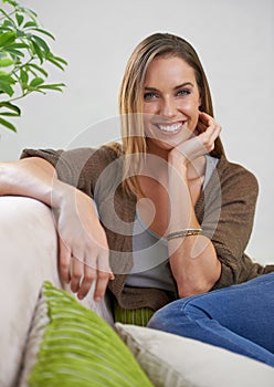 Happy, portrait and girl on couch to relax for comfort or rest on Saturday afternoon, peace and unwind. Female person