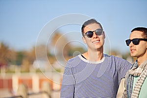 Happy, portrait and queer male couple on walk, promenade and outside for travel on holiday. LGBT, love and affection