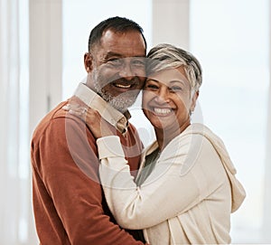 Happy, portrait and senior couple in home living room, bonding together and hug. Face smile, man and Indian woman in