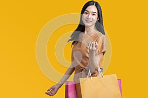 Happy Portrait smiling young asian woman holding shopping bags , happy beautiful shopaholic asia female shopping bag isolated on