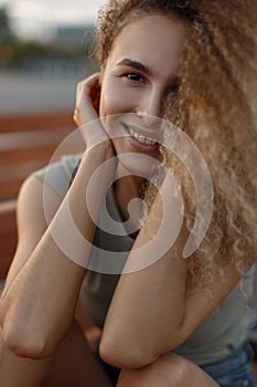 Happy beautiful portrait of a curly young girl