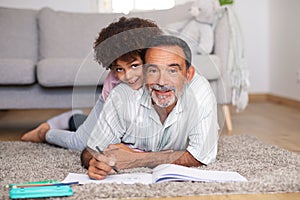 Happy Portuguese Grandpa And Grandson Sketching Together Posing At Home