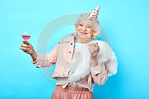 Happy positive funny senior woman having fun in the party