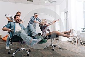 Happy positive people riding in the swivel chairs