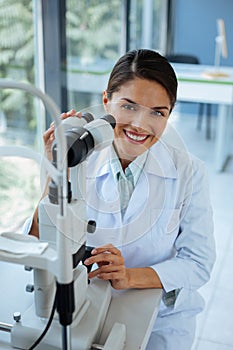 Happy positive woman being at work in the clinic