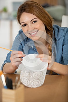 happy pottery artist painting