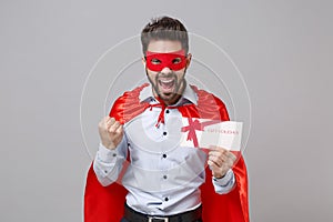Happy powerful business man in superhero suit have supernatural abilities isolated on grey background. Achievement