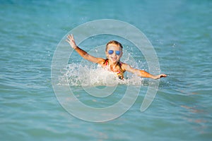 Cute young girl playing in the sea.