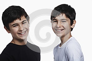 Happy Preadolescent Brothers Against White Background