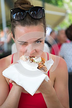 Happy preatty girl or Woman eating sandwich gyros.