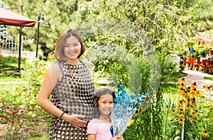 Happy pregnant asian mom and child girl hugging. The concept of childhood and family.