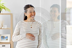 happy pregnant asian woman at home