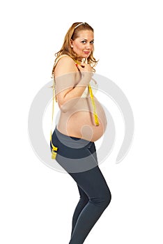 Happy pregnant holding centimeter