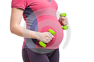 Happy pregnant mom exercising with dumbbells