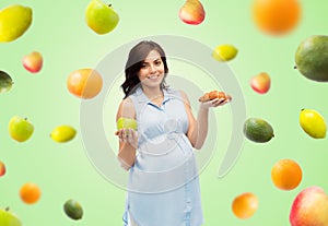 Happy pregnant woman with apple and croissant