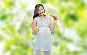 Happy pregnant woman with apple and croissant
