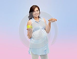 Happy pregnant woman with apple and croissant