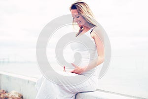 Happy pregnant woman bonding with her unborn child