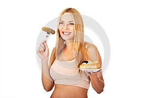 Happy pregnant woman with cake and pickles