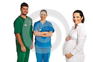 Happy pregnant woman and doctors