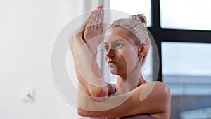 Happy pregnant woman doing yoga at home