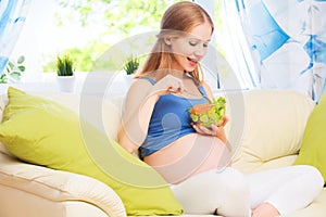 Happy pregnant woman eats healthy food vegetable salad