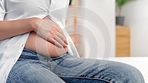 Happy pregnant woman enjoy pregnancy touching tummy relaxing at peace home with love closeup