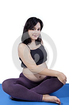 Happy pregnant woman exercising