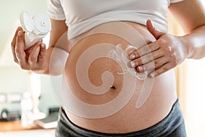 Happy pregnant woman and expecting baby at home