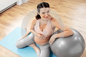 Happy pregnant woman with fitball at home