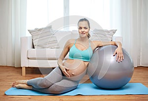 Happy pregnant woman with fitball at home