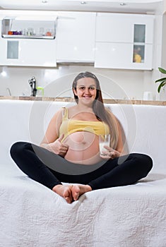 Happy pregnant woman giving a thumbs up