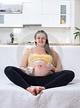 Happy pregnant woman giving a thumbs up