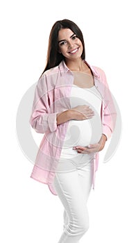 Happy pregnant woman holding her belly on  background