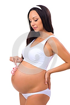 Happy pregnant woman holding near tummy pink label Girl for newborn daughter