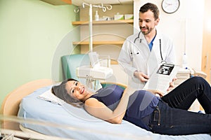 Happy pregnant woman in a hospital bed