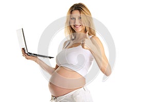 Happy pregnant woman with laptop