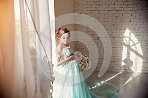 Happy Pregnant woman in long evening dress touching belly hands. Waiting the birth of a child, a woman in her eighth month