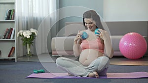 Happy pregnant woman massaging her body with balls, enjoying pregnancy, relax