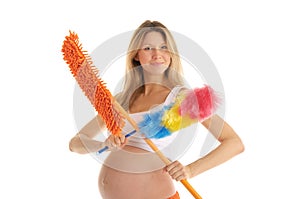 Happy pregnant woman with a mop and brush