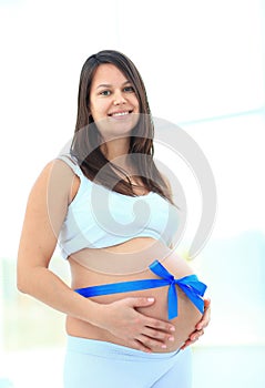 Happy pregnant woman smiling. looking at the camera