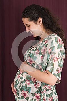 Happy Pregnant Woman touching her belly